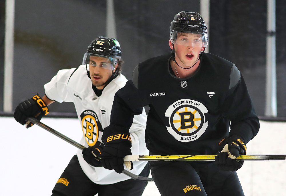 Mason Lohrei and Marat Khusnutdinov at Bruins practice